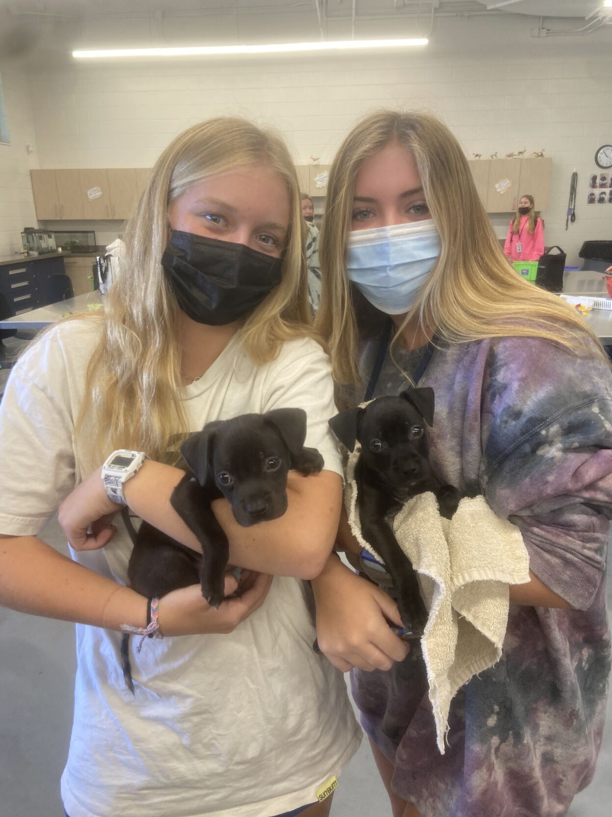 2 girls holding puppies.jpeg